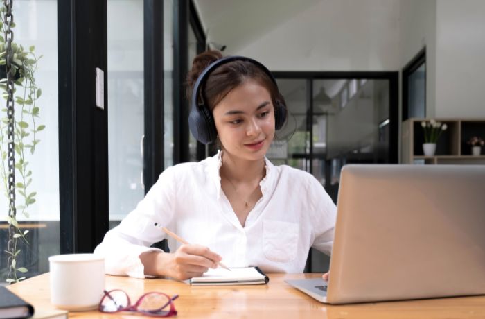 Asian woman interpreter write translation from foreign language