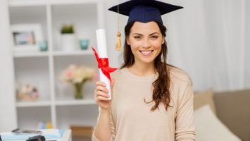 Happy Female Student with Diploma at Home